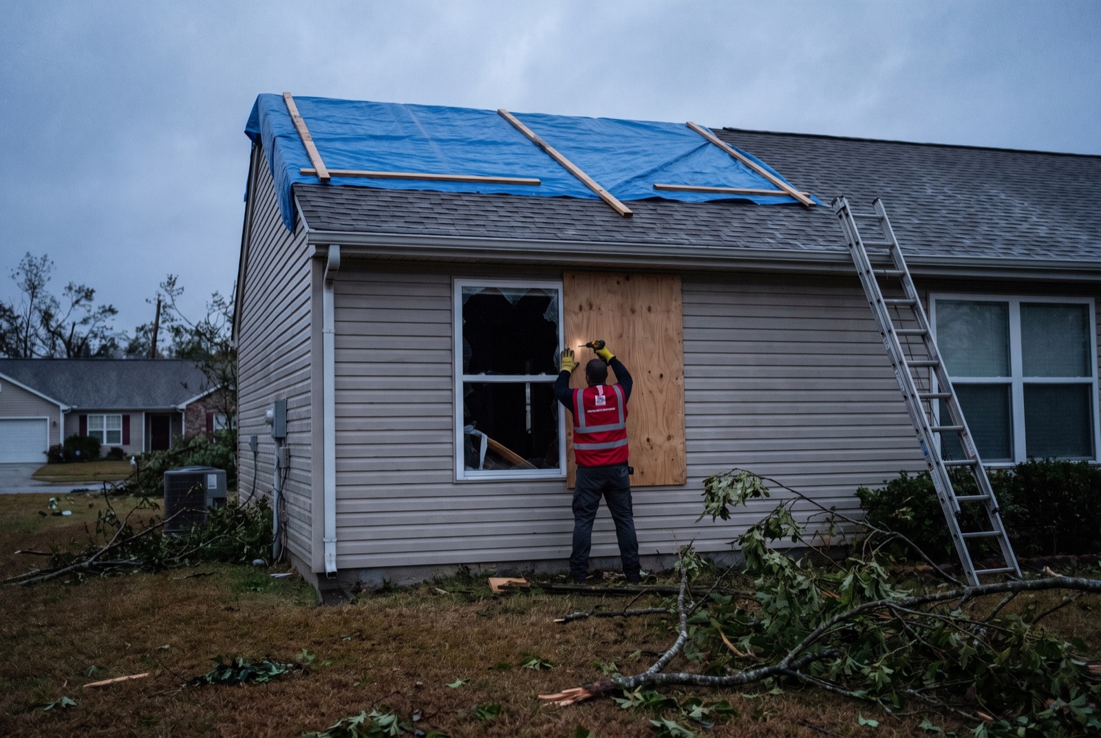 Emergency board-up and roof tarping after storm damage — illustrating: who is responsible if a neighbor's tree falls on my house