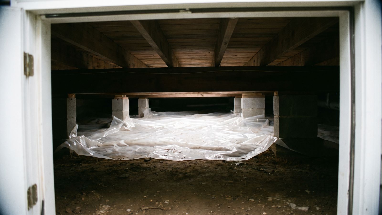Vapor barrier over a crawl space dirt floor A plastic vapor barrier laid across the dirt floor of a crawl space, the first step against crawl space moisture