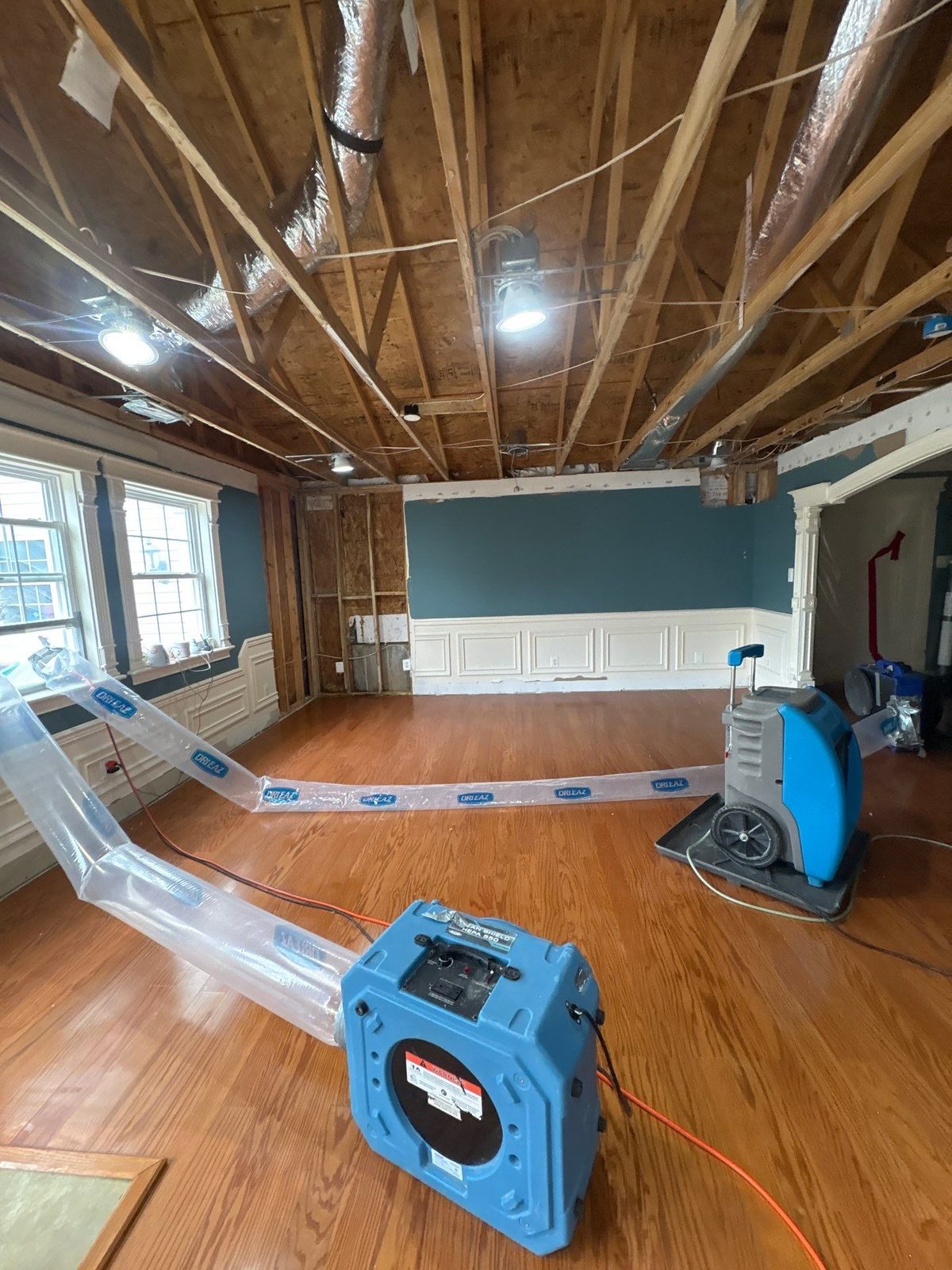 Oak plank floor with the ceiling open to the joists above, a ducted unit and a dehumidifier, Manassas, VA, April 2026