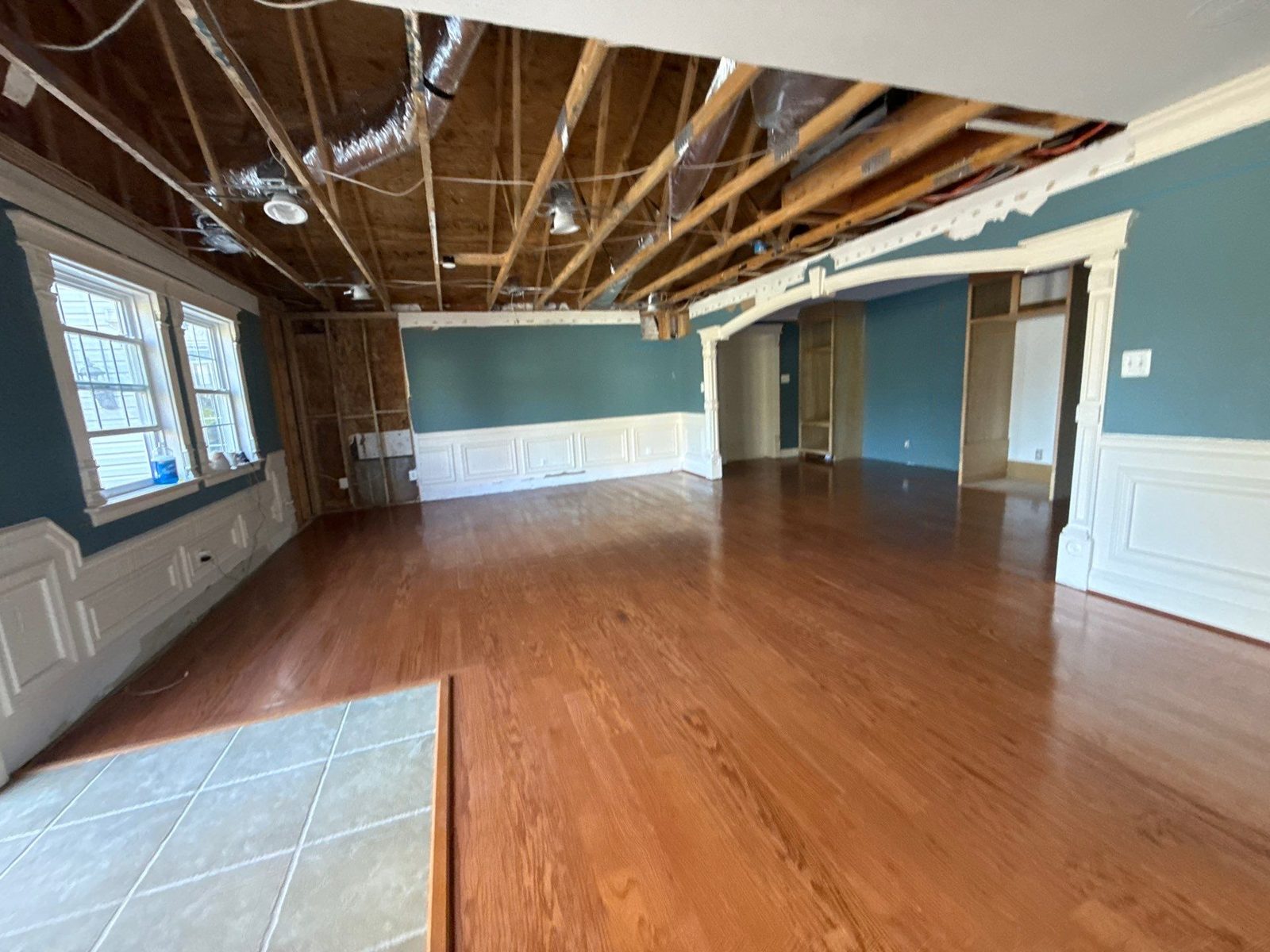 Room with the ceiling open to the joists and oak plank boards across the floor, Manassas, VA, April 2026