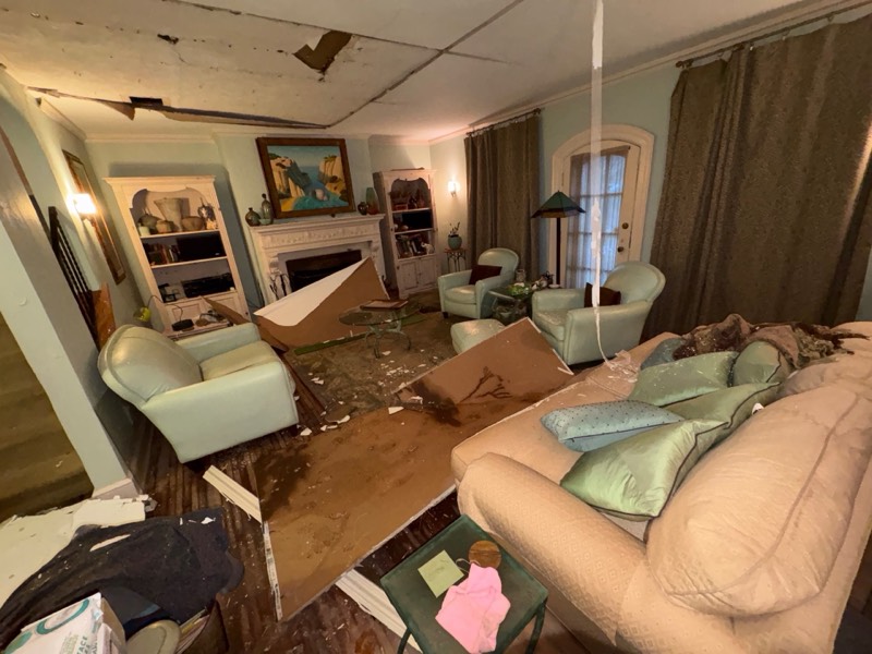 Finished living room with collapsed ceiling drywall from a water leak on a documented Restoration Doctor project