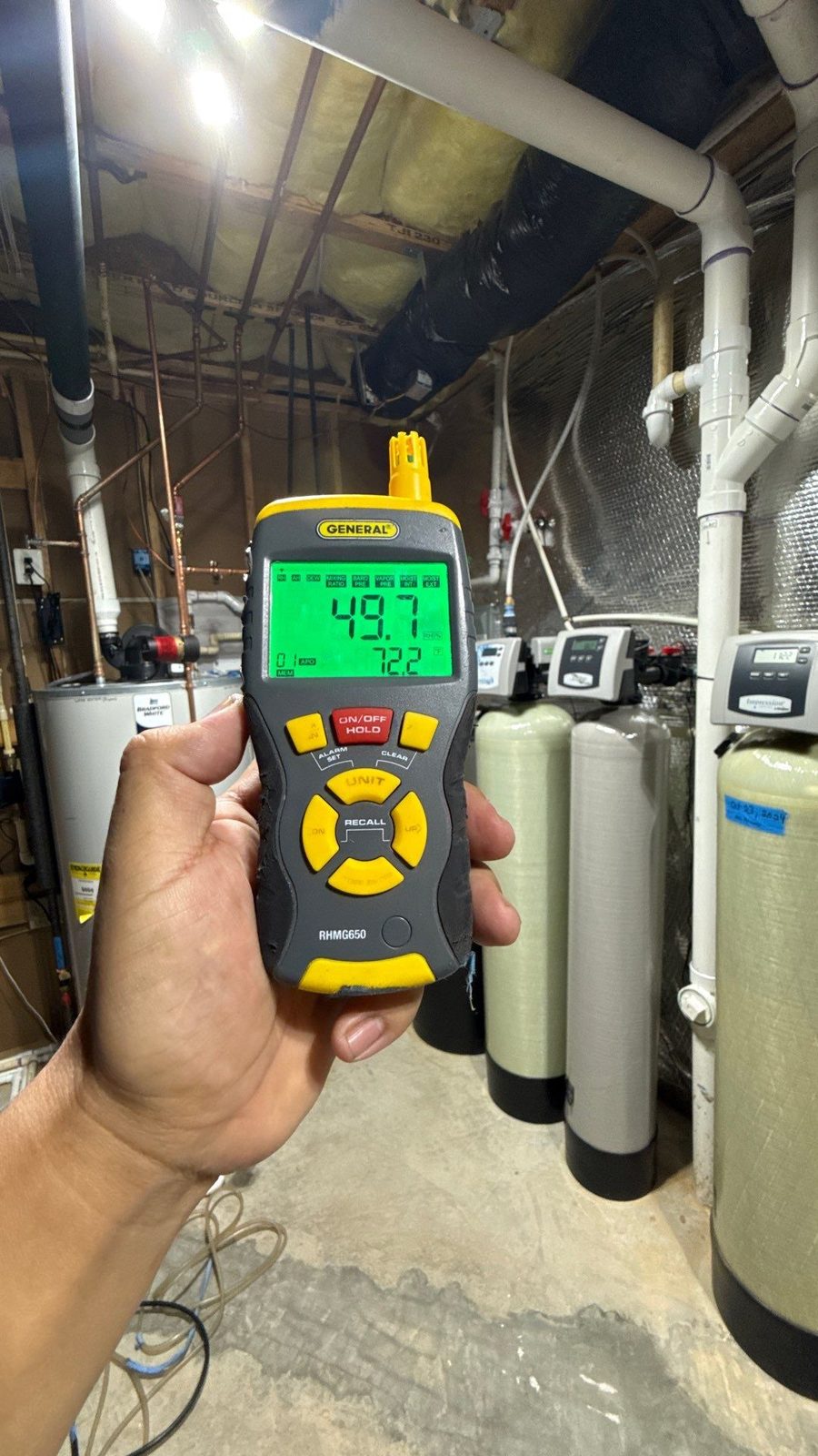 Handheld meter reading 49.7 percent relative humidity in a basement mechanical room, McLean, VA, October 25, 2025