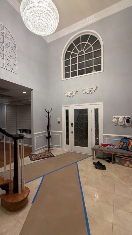 Two-story foyer of a Centreville, VA home with floor protection during water damage restoration