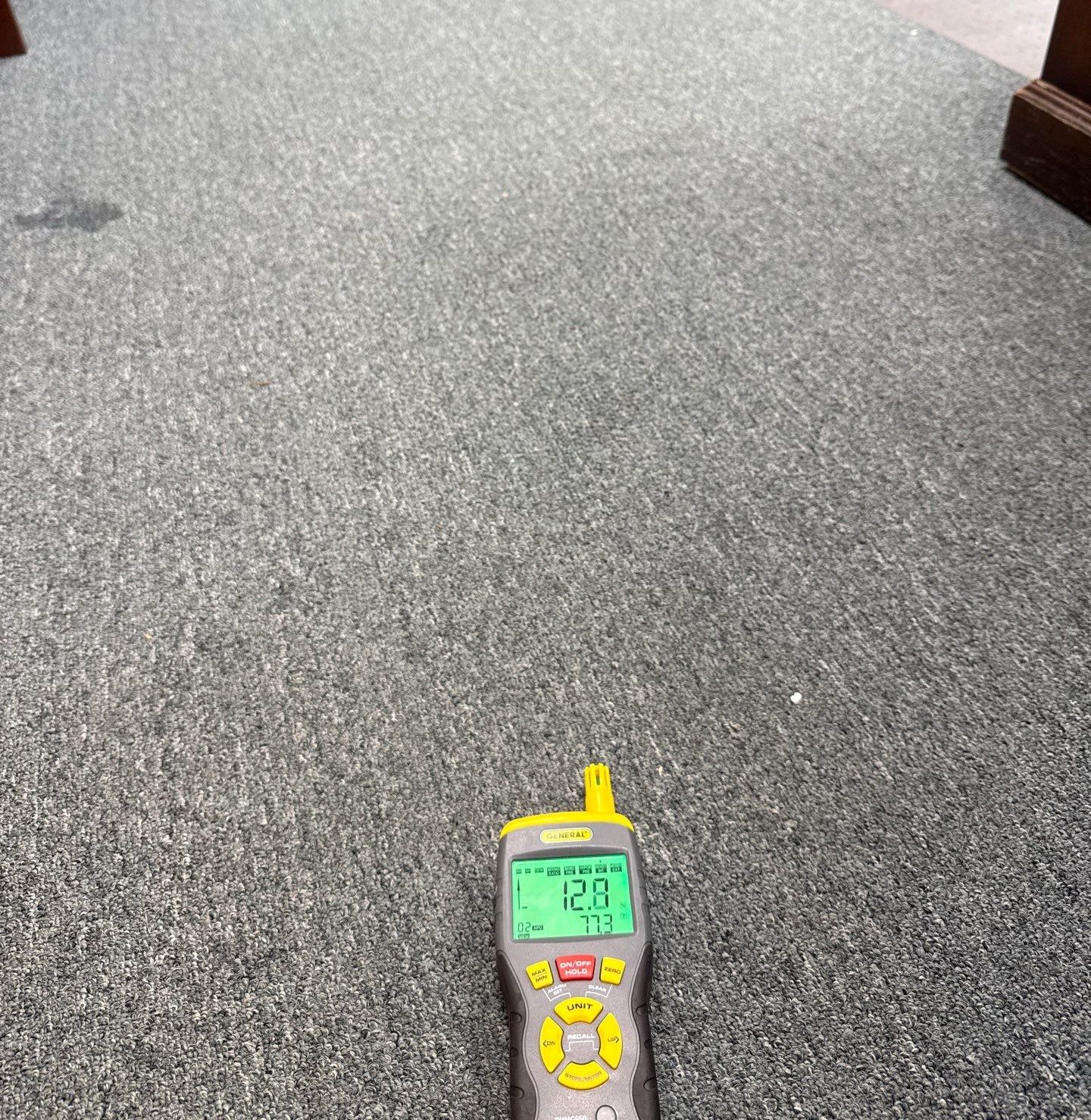 Moisture meter lying on carpet, reading 12.8, Sterling, VA, September 23, 2025